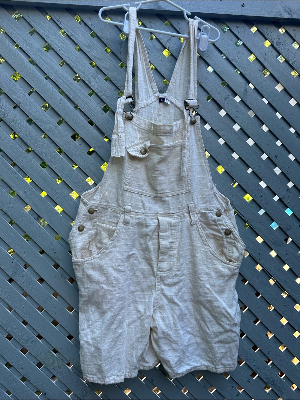 cream cotton overalls with adjustable straps and pockets